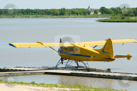 To use this stock image in your creative project, please select the size you need over to the right and click the "Add to Cart" button.
Your downloaded image will come with the Cutcaster watermark removed so don’t worry about the watermark you see on this page. Yellow Seaplane stock photo, A yellow seaplane docked on the river during the day by Richard Nelson