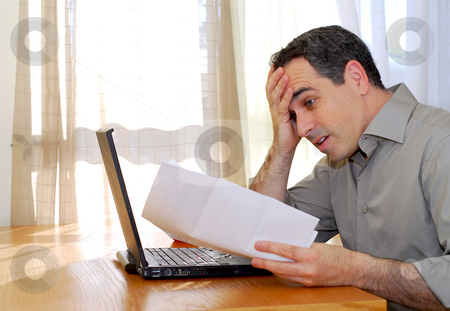 To use this stock image in your creative project, please select the size you need over to the right and click the "Add to Cart" button.
Your downloaded image will come with the Cutcaster watermark removed so don’t worry about the watermark you see on this page. Man with laptop stock photo, Man sitting at a desk looking at bills with horror by Elena Elisseeva