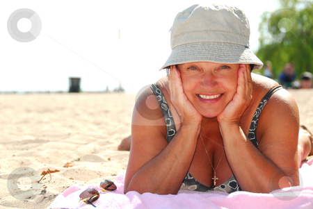 To use this stock image in your creative project, please select the size you need over to the right and click the "Add to Cart" button.
Your downloaded image will come with the Cutcaster watermark removed so don’t worry about the watermark you see on this page. Mature woman beach stock photo, Mature woman lying on a sandy beach by Elena Elisseeva