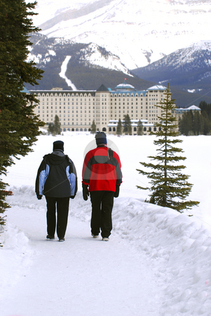 To use this stock image in your creative project, please select the size you need over to the right and click the "Add to Cart" button.
Your downloaded image will come with the Cutcaster watermark removed so don’t worry about the watermark you see on this page. Lake Louise stock photo, A couple talking a walk in on scenic winter path at Chateau Lake Louise by Elena Elisseeva