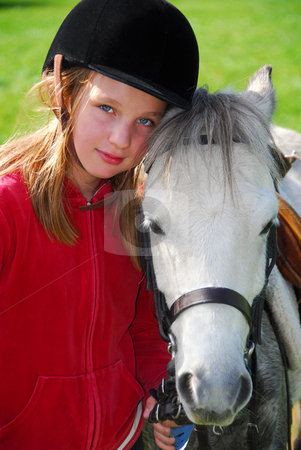 To use this stock image in your creative project, please select the size you need over to the right and click the "Add to Cart" button.
Your downloaded image will come with the Cutcaster watermark removed so don’t worry about the watermark you see on this page. Girl and pony stock photo, Portrait of a young girl with a white pony by Elena Elisseeva