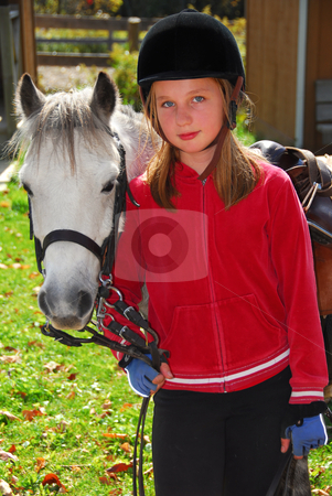 To use this stock image in your creative project, please select the size you need over to the right and click the "Add to Cart" button.
Your downloaded image will come with the Cutcaster watermark removed so don’t worry about the watermark you see on this page. Girl and pony stock photo, Portrait of a young girl with a white pony by Elena Elisseeva