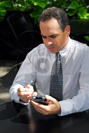 To use this stock image in your creative project, please select the size you need over to the right and click the "Add to Cart" button.
Your downloaded image will come with the Cutcaster watermark removed so don’t worry about the watermark you see on this page. Businessman pda stock photo, Businessman holding pda by Elena Elisseeva