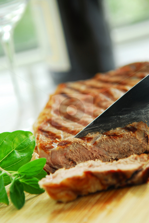 To use this stock image in your creative project, please select the size you need over to the right and click the "Add to Cart" button.
Your downloaded image will come with the Cutcaster watermark removed so don’t worry about the watermark you see on this page. Grilled steak stock photo, Grilled New York steak being cut on a cutting board by Elena Elisseeva