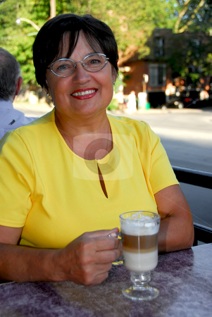To use this stock image in your creative project, please select the size you need over to the right and click the "Add to Cart" button.
Your downloaded image will come with the Cutcaster watermark removed so don’t worry about the watermark you see on this page. Mature woman coffee stock photo, Smiling mature woman in outdoor cafe holding a coffee by Elena Elisseeva