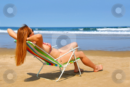 To use this stock image in your creative project, please select the size you need over to the right and click the "Add to Cart" button.
Your downloaded image will come with the Cutcaster watermark removed so don’t worry about the watermark you see on this page. Woman beach stock photo, Young woman relaxing on a beach in a chair by Elena Elisseeva