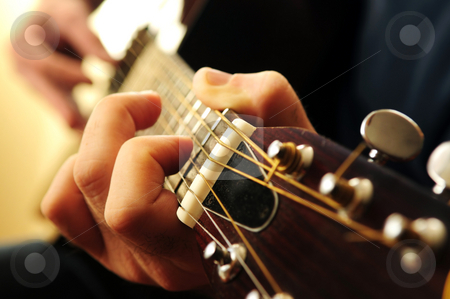 To use this stock image in your creative project, please select the size you need over to the right and click the "Add to Cart" button.
Your downloaded image will come with the Cutcaster watermark removed so don’t worry about the watermark you see on this page. Man playing a guitar stock photo, Hands of a person playing an acoustic guitar close up by Elena Elisseeva