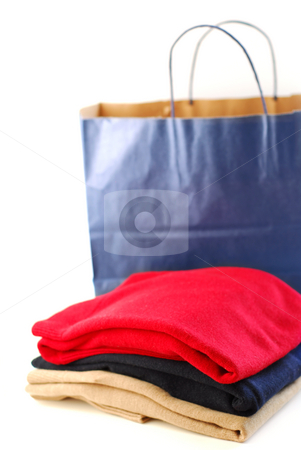 To use this stock image in your creative project, please select the size you need over to the right and click the "Add to Cart" button.
Your downloaded image will come with the Cutcaster watermark removed so don’t worry about the watermark you see on this page. Clothes and shopping bag stock photo, Folded sweaters with a paper shopping bag on white background by Elena Elisseeva