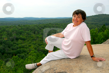 To use this stock image in your creative project, please select the size you need over to the right and click the "Add to Cart" button.
Your downloaded image will come with the Cutcaster watermark removed so don’t worry about the watermark you see on this page. Woman relaxing at edge cliff stock photo, Mature woman sitting on scenic cliff edge smiling by Elena Elisseeva