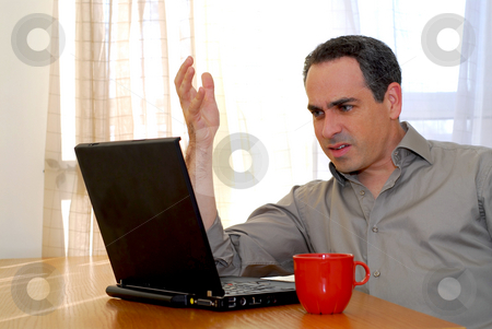 To use this stock image in your creative project, please select the size you need over to the right and click the "Add to Cart" button.
Your downloaded image will come with the Cutcaster watermark removed so don’t worry about the watermark you see on this page. Man with laptop stock photo, Man sitting at a desk and looking into his computer by Elena Elisseeva