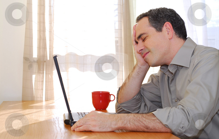 To use this stock image in your creative project, please select the size you need over to the right and click the "Add to Cart" button.
Your downloaded image will come with the Cutcaster watermark removed so don’t worry about the watermark you see on this page. Man with laptop stock photo, Man sitting at a desk and looking into his computer by Elena Elisseeva