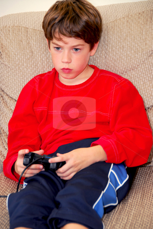 To use this stock image in your creative project, please select the size you need over to the right and click the "Add to Cart" button.
Your downloaded image will come with the Cutcaster watermark removed so don’t worry about the watermark you see on this page. Boy video game stock photo, Young boy playing a video game sitting on a couch by Elena Elisseeva
