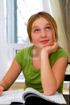 To use this stock image in your creative project, please select the size you need over to the right and click the "Add to Cart" button.
Your downloaded image will come with the Cutcaster watermark removed so don’t worry about the watermark you see on this page. School girl stock photo, Young school girl doing homework at her desk by Elena Elisseeva