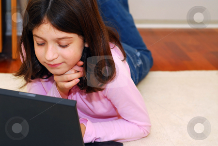 To use this stock image in your creative project, please select the size you need over to the right and click the "Add to Cart" button.
Your downloaded image will come with the Cutcaster watermark removed so don’t worry about the watermark you see on this page. Girl computer stock photo, Portrait of a young girl lying on the floor and looking into computer by Elena Elisseeva