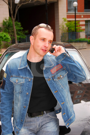 To use this stock image in your creative project, please select the size you need over to the right and click the "Add to Cart" button.
Your downloaded image will come with the Cutcaster watermark removed so don’t worry about the watermark you see on this page. Man talking on cell phone stock photo, Man talking on a cell phone leanind on a hood of his car by Elena Elisseeva
