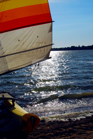 To use this stock image in your creative project, please select the size you need over to the right and click the "Add to Cart" button.
Your downloaded image will come with the Cutcaster watermark removed so don’t worry about the watermark you see on this page. Sailboat backlit stock photo, Catamaran on a beach with backlit sail by Elena Elisseeva