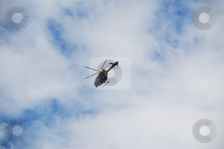 To use this stock image in your creative project, please select the size you need over to the right and click the "Add to Cart" button.
Your downloaded image will come with the Cutcaster watermark removed so don’t worry about the watermark you see on this page. Police Helicopter in a Cloudy Blue Sky stock photo, A photograph of a helicopter with moving rotar blades, far away under a blue sky by Philippa Willitts