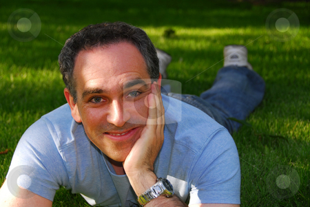 To use this stock image in your creative project, please select the size you need over to the right and click the "Add to Cart" button.
Your downloaded image will come with the Cutcaster watermark removed so don’t worry about the watermark you see on this page. Man relaxing outside stock photo, Man relaxing outside on green grass by Elena Elisseeva