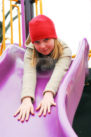 To use this stock image in your creative project, please select the size you need over to the right and click the "Add to Cart" button.
Your downloaded image will come with the Cutcaster watermark removed so don’t worry about the watermark you see on this page. Girl on playground stock photo, Young girl in a red hat on playground, about to go down the slides by Elena Elisseeva
