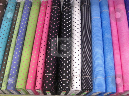 To use this stock image in your creative project, please select the size you need over to the right and click the "Add to Cart" button.
Your downloaded image will come with the Cutcaster watermark removed so don’t worry about the watermark you see on this page. Rolls of fabric stock photo, A variety of colorful fabrics in different textures are neatly displayed on a shelf inside a retail store. by Rebecca Mosoetsa