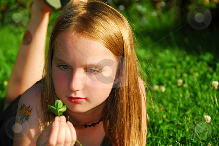 To use this stock image in your creative project, please select the size you need over to the right and click the "Add to Cart" button.
Your downloaded image will come with the Cutcaster watermark removed so don’t worry about the watermark you see on this page. Girl grass stock photo, Young girl lying on green grass outside holding a green plant by Elena Elisseeva