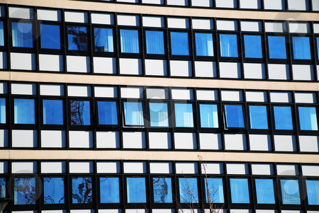 To use this stock image in your creative project, please select the size you need over to the right and click the "Add to Cart" button.
Your downloaded image will come with the Cutcaster watermark removed so don’t worry about the watermark you see on this page. Modern Office Building with Window Reflections stock photo, A photograph of an example of modern architecture, with opposing buildings, the blue sky, and a construction crane in reflection. by Philippa Willitts