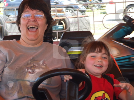 To use this stock image in your creative project, please select the size you need over to the right and click the "Add to Cart" button.
Your downloaded image will come with the Cutcaster watermark removed so don’t worry about the watermark you see on this page. Bumper Cars stock photo, Young child is driving the bumper car while adult rides along. by Marburg
