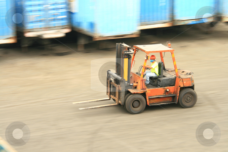 To use this stock image in your creative project, please select the size you need over to the right and click the "Add to Cart" button.
Your downloaded image will come with the Cutcaster watermark removed so don’t worry about the watermark you see on this page. Forklift in motion stock photo, Orange forklift in motion at a ship port by Jonas Marcos San Luis