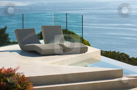 To use this stock image in your creative project, please select the size you need over to the right and click the "Add to Cart" button.
Your downloaded image will come with the Cutcaster watermark removed so don’t worry about the watermark you see on this page. Custom Luxury Pool and Chairs stock photo, Custom Luxury Pool and Chairs Abstract Overlooking the Ocean by Andy Dean