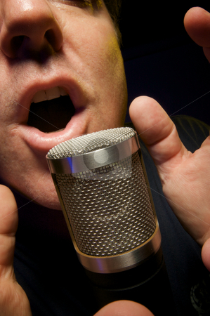 To use this stock image in your creative project, please select the size you need over to the right and click the "Add to Cart" button.
Your downloaded image will come with the Cutcaster watermark removed so don’t worry about the watermark you see on this page. Vocalist singing into Microphone stock photo, Passionate Vocalist & Microphone by Andy Dean