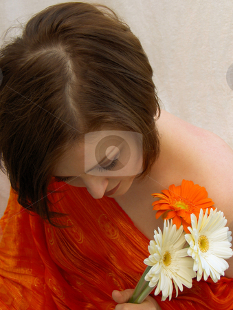 To use this stock image in your creative project, please select the size you need over to the right and click the "Add to Cart" button.
Your downloaded image will come with the Cutcaster watermark removed so don’t worry about the watermark you see on this page. Soft stock photo, A beautiful brunette, wearing red, with a bouquet of daisies, looking down demurely. by Jessica Tooley