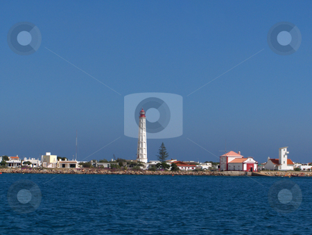 To use this stock image in your creative project, please select the size you need over to the right and click the "Add to Cart" button.
Your downloaded image will come with the Cutcaster watermark removed so don’t worry about the watermark you see on this page. Portugese Lighthouse stock photo, A lighthouse and white buildings in a village in the Algarve region of Portugal. by Jessica Tooley