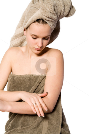 To use this stock image in your creative project, please select the size you need over to the right and click the "Add to Cart" button.
Your downloaded image will come with the Cutcaster watermark removed so don’t worry about the watermark you see on this page. Young woman appying some creme stock photo, Young woman in towel on a white background applying creme by Frenk and Danielle Kaufmann