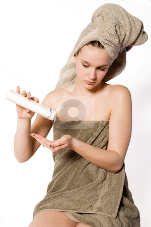 To use this stock image in your creative project, please select the size you need over to the right and click the "Add to Cart" button.
Your downloaded image will come with the Cutcaster watermark removed so don’t worry about the watermark you see on this page. Woman is getting some creme on her hand stock photo, Young woman in towel on a white background with some moisterizer by Frenk and Danielle Kaufmann