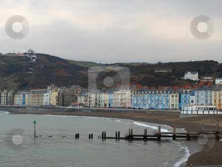 To use this stock image in your creative project, please select the size you need over to the right and click the "Add to Cart" button.
Your downloaded image will come with the Cutcaster watermark removed so don’t worry about the watermark you see on this page. Aberystwyth Oceanfront stock photo, Edwardian and Victorian architecture dominates the ocean-front street in Aberystwyth, Wales. by Jessica Tooley