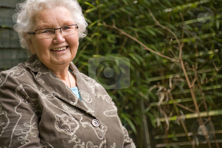 To use this stock image in your creative project, please select the size you need over to the right and click the "Add to Cart" button.
Your downloaded image will come with the Cutcaster watermark removed so don’t worry about the watermark you see on this page. Grey woman sitting relaxed stock photo, Outside portrait of an elderly woman smiling by Frenk and Danielle Kaufmann