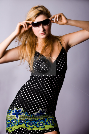 To use this stock image in your creative project, please select the size you need over to the right and click the "Add to Cart" button.
Your downloaded image will come with the Cutcaster watermark removed so don’t worry about the watermark you see on this page. Sexy woman and sunglasses stock photo, Beautiful girl with a pair off sunglasses in the studio by Frenk and Danielle Kaufmann