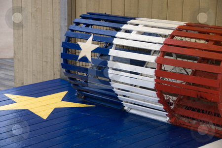 To use this stock image in your creative project, please select the size you need over to the right and click the "Add to Cart" button.
Your downloaded image will come with the Cutcaster watermark removed so don’t worry about the watermark you see on this page. Acadian Lobster Trap stock photo, A lobster trap with the Acadian flag painted on it by Maria Bell