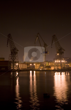 To use this stock image in your creative project, please select the size you need over to the right and click the "Add to Cart" button.
Your downloaded image will come with the Cutcaster watermark removed so don’t worry about the watermark you see on this page. Industrial stock photo, Industrial image of cranes and factories at night by Ivan Montero
