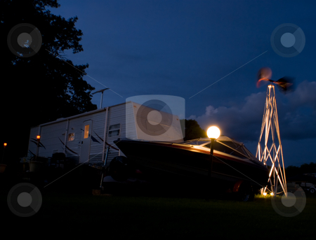 To use this stock image in your creative project, please select the size you need over to the right and click the "Add to Cart" button.
Your downloaded image will come with the Cutcaster watermark removed so don’t worry about the watermark you see on this page. Camping stock photo, Night view of a camping trailer and boat by Richard Nelson