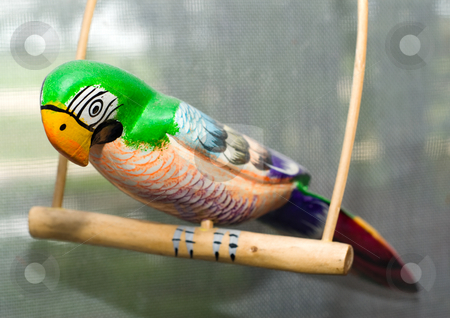 To use this stock image in your creative project, please select the size you need over to the right and click the "Add to Cart" button.
Your downloaded image will come with the Cutcaster watermark removed so don’t worry about the watermark you see on this page. Wooden Parrot stock photo, A painted wooden parrot sitting on a perch by Richard Nelson