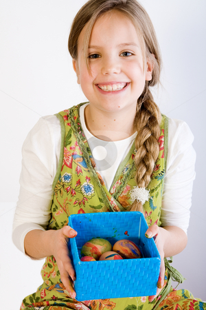 To use this stock image in your creative project, please select the size you need over to the right and click the "Add to Cart" button.
Your downloaded image will come with the Cutcaster watermark removed so don’t worry about the watermark you see on this page. Young girl presenting a box with painted eggs stock photo, Studio portrait of a young blond girl who is presenting a blue box with her painted easter eggs by Frenk and Danielle Kaufmann