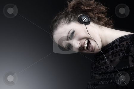 To use this stock image in your creative project, please select the size you need over to the right and click the "Add to Cart" button.
Your downloaded image will come with the Cutcaster watermark removed so don’t worry about the watermark you see on this page. Woman with long curly hair enjoying nusic stock photo, Portrait of a woman with long curly hair and headphones by Frenk and Danielle Kaufmann