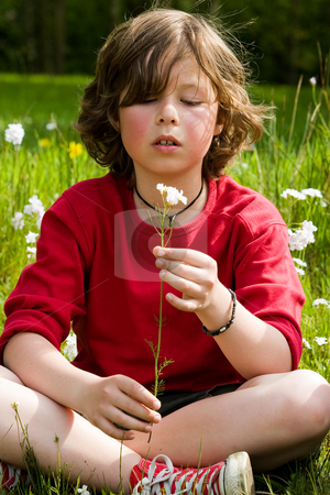 To use this stock image in your creative project, please select the size you need over to the right and click the "Add to Cart" button.
Your downloaded image will come with the Cutcaster watermark removed so don’t worry about the watermark you see on this page. Looking to the flower stock photo, Young boy is looking to his flower by Frenk and Danielle Kaufmann