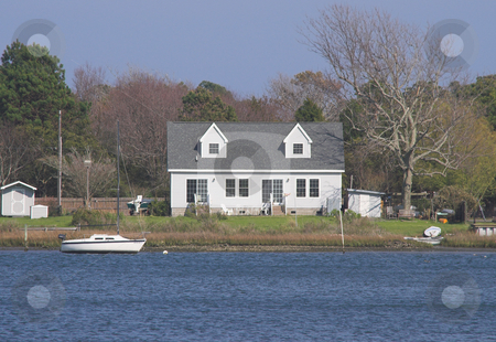 To use this stock image in your creative project, please select the size you need over to the right and click the "Add to Cart" button.
Your downloaded image will come with the Cutcaster watermark removed so don’t worry about the watermark you see on this page. Seaside House and Sailboat stock photo, A house by the sea and a boat. by Robert Byron