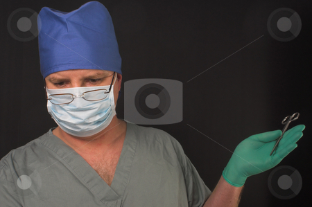 To use this stock image in your creative project, please select the size you need over to the right and click the "Add to Cart" button.
Your downloaded image will come with the Cutcaster watermark removed so don’t worry about the watermark you see on this page. Surgeon stock photo, A medical doctor dressed in scrubs performing surgery. by Robert Byron