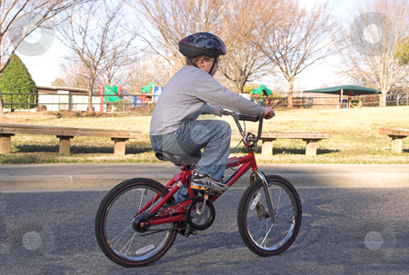 To use this stock image in your creative project, please select the size you need over to the right and click the "Add to Cart" button.
Your downloaded image will come with the Cutcaster watermark removed so don’t worry about the watermark you see on this page. Boy Riding a Bike stock photo, A young boy riding his bike. by Robert Byron