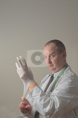 To use this stock image in your creative project, please select the size you need over to the right and click the "Add to Cart" button.
Your downloaded image will come with the Cutcaster watermark removed so don’t worry about the watermark you see on this page. Proctologist stock photo, A proctologist preparing for a patient examination. by Robert Byron