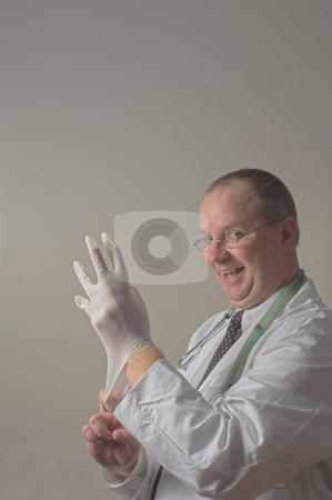 To use this stock image in your creative project, please select the size you need over to the right and click the "Add to Cart" button.
Your downloaded image will come with the Cutcaster watermark removed so don’t worry about the watermark you see on this page. Goofy Doctor stock photo, A goofy doctor putting on a rubber surgical glove. by Robert Byron