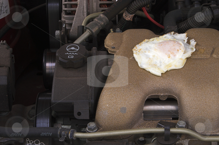 To use this stock image in your creative project, please select the size you need over to the right and click the "Add to Cart" button.
Your downloaded image will come with the Cutcaster watermark removed so don’t worry about the watermark you see on this page. Frying an Egg on a Car Motor stock photo, Cooking an egg on an automobile engine. by Robert Byron
